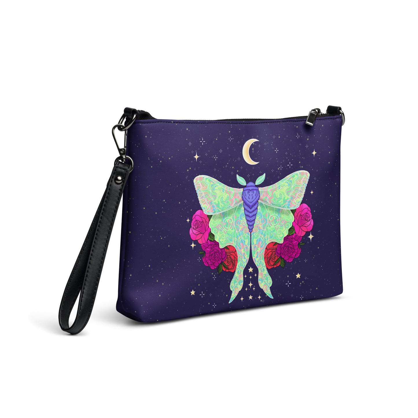 A wristlet clutch bag with a black strap, featuring a dark purple background printed with a large pastel green and purple moth, pink and red roses, and a small gold crescent moon surrounded by stars.