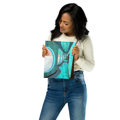 A woman holding a square canvas print featuring an abstract teal, turquoise, and gray design, wearing a cream long-sleeve top and blue jeans against a plain white background.