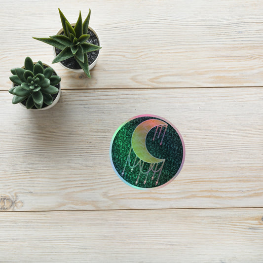 Druzy Moon holographic sticker 4x4 inch – hand-drawn crescent moon with jewel drips on a dark leafy background, rainbow holographic border, by Brittyliz Art
