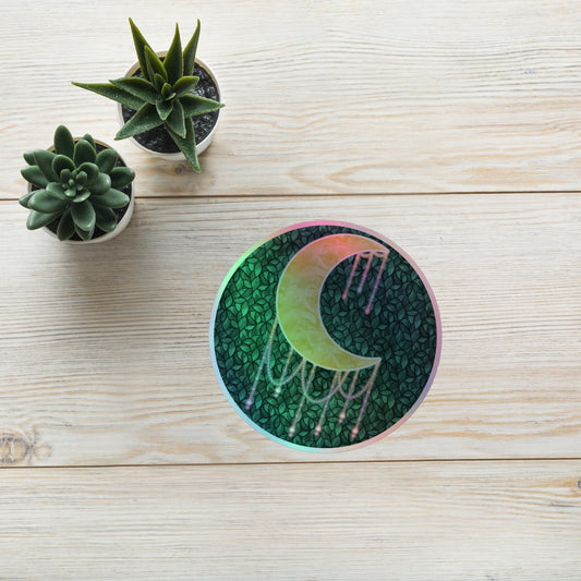 Druzy Moon holographic sticker 5.5x5.5 inch – hand-drawn crescent moon with jewel drips on a dark leafy background, rainbow holographic border, by Brittyliz Art