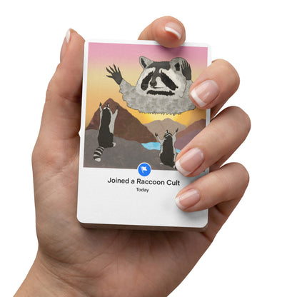 Hand holding Raccoon Cult poker playing card - hand-drawn meme art gift idea