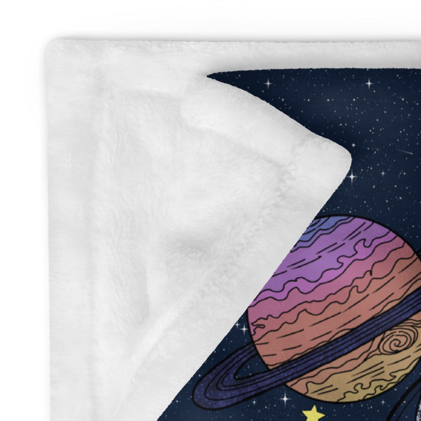 Close-up of soft white reverse side and hand-drawn Saturn planet detail on Milky Way Kitty blanket