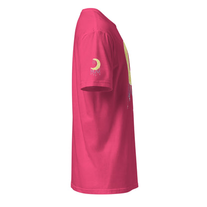 A bright pink t-shirt viewed from a side profile view, featuring a gold crescent moon graphic with a dripping beads effect on the left sleeve and a matching graphic on the side.